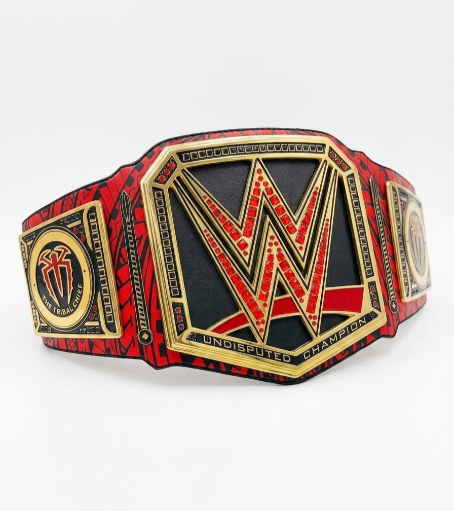 A WWE Undisputed Champion belt featuring a large central gold and red 'W' emblem on a black background, with red and black patterned straps and gold borders, photographed on a white background.