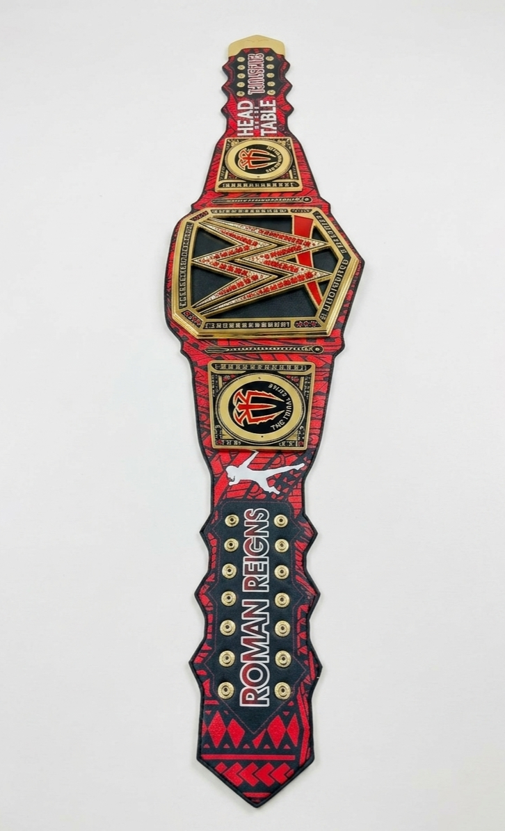 A WWE Roman Reigns World Champion belt replica or patch shown vertically against a plain white background.